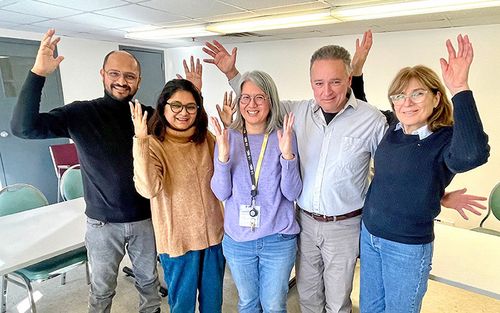 Educator Brenda Too (centre) and parents applaud in American Sign Language during an ASL Parent Group class at the MAB site. From left: Tanmoy Pathak, Karabi Sarmah, Evan Saviolidis and Debbie Manessis.
