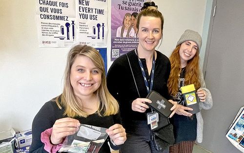 Team members from our CIUSSS hold harm-reduction material in the Rapid Access to Addiction Medicine office at CLSC Métro. From left: Psycho-educator Lorrie Marcotte; Catherine Roberge, Program Manager for Addiction and Homelessness; and Social Worker Tiffany Verdon, Social Worker and Clinical Coordinator.